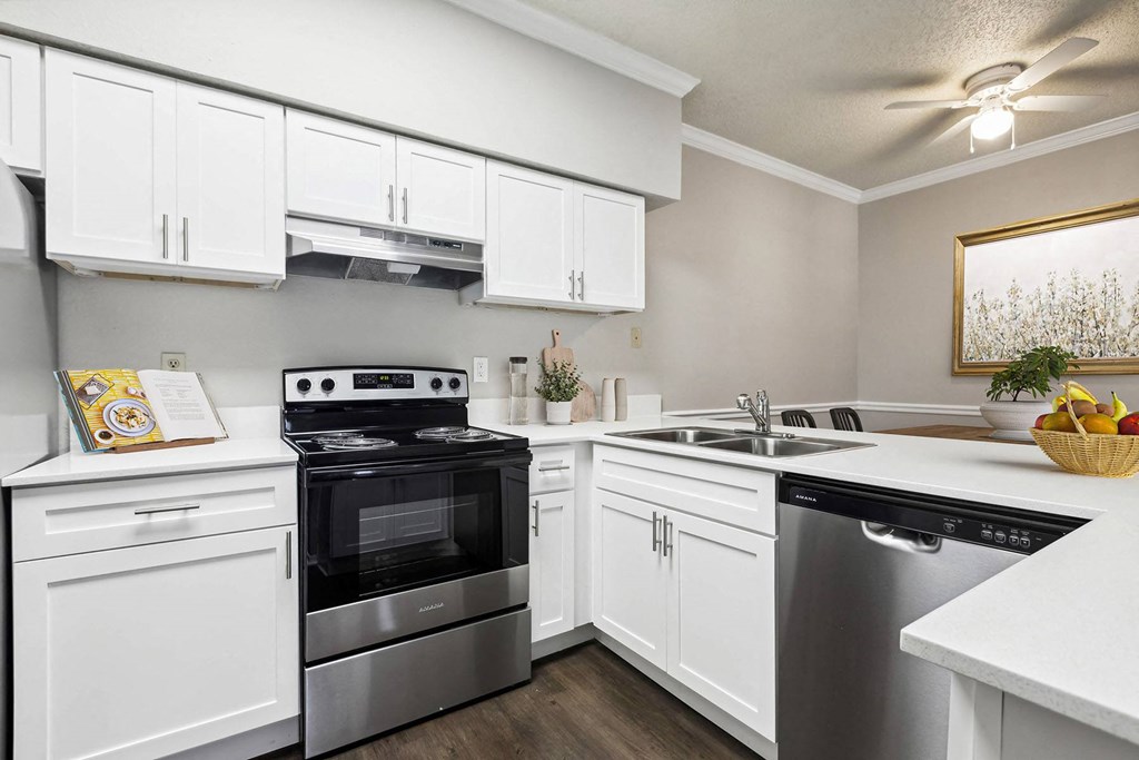 a kitchen with stainless steel appliances and white cabinets
